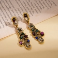 Vintage geometric gold earrings with colorful rhinestones set on an open book background - Vintage Long Dangle Earrings / Multi-color (925 Sterling Silver Pin)