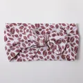 Detailed view of elastic nylon baby headband featuring a large American football print bow - White Football Pattern