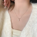 Elegant S925 silver knot necklace with a round freshwater pearl on a model's neck - 925 Silver / Pearl Knot - Platinum