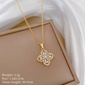 Macro shot of gold four-leaf clover necklace with sparkling cubic zirconia on silk fabric - Necklace (D141) / White