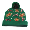 Detail of LED power button on green knitted Christmas hat with gingerbread pattern - One Size / Green Gingerbread (LED)