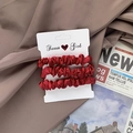 Three-pack set of glossy dark burgundy satin scrunchies displayed on a card - Red
