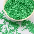 Green 2mm glass seed beads for DIY jewelry making in a white ceramic bowl - Green
