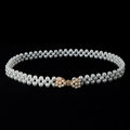 Detail view of a white pearl beaded belt with an elegant gold bow-shaped buckle - Gold-Tone Rhinestone Bow Artificial Pearl Clasp (Style 7)