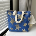 Blue canvas tote bag featuring a golden turtle print and beige rope handles - Gold Tortoise