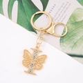 Detail of golden letter I keychain with sparkling crystal inlay and butterfly wings - Letter I