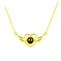 Golden heart necklace with wings and dark projection stone on a white background - Winged Heart Gold