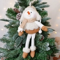 Hanging plush snowman ornament with beige knit hat and scarf on Christmas tree - Girl Snowman