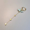 Detail of bohemian gold earrings with heart charms and natural light green stones - Amazonite