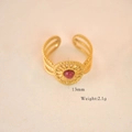 Macro shot of gold-plated bohemian ring with red gemstone and 13mm woven texture detail - Rhodonite