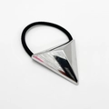 Macro shot of silver pyramid charm on black elastic hair tie with polished metal finish - 3D Pyramid Triangle / Silver