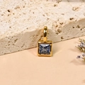 Square blue zircon pendant with 18K gold plating on a textured stone background - September/Blue