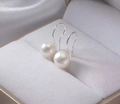 Macro shot of elegant natural white pearl earrings with silver hooks in a jewelry box - White Gold / 9mm White Natural Pearl Earrings