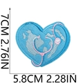 Detail of medical heart patch with blue world map embroidery and pink stethoscope detail - No.12 Earth Heart Stethoscope