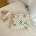 Detail of floral quilted cosmetic bag with pink roses and simple wish label on desk - Pink Large Floral