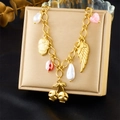 Detailaufnahme eines goldenen Charm-Armbands mit Totenkopf, Kirsche und Flügelanhängern - Totenkopf Flügel Kirsche Perle Armband Stil (N3416)