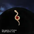 Detailed macro view of snake brooch with ruby and gold metal finish, size 1.5x4.6cm - Gold Snake with Red Gem (XZ24170)