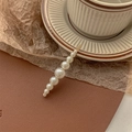 Detailed close-up of a gold pearl hair clip resting on a striped ceramic cup with warm tones - Small Size Mixed Pearls-Gold Bobby Pin