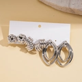 Detail of silver earring set featuring textured hoops and studs on display card - Silver Jewelry Set / Silver