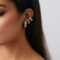 Modern silver C-shaped bread ear cuff with a liquid metal design on a model's ear - Silver (3697)
