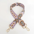 Detail of geometric ethnic jacquard bag strap with gold metal hooks and purple diamond pattern - Lotus Root Pink Green Purple