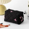 Quilted black floral cosmetic bag with pink bow embroidery and secure zipper closure - Embroidered Black Bow