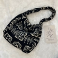 Detail of plush black and white geometric pattern bag with silver magnetic closure - Ethnic Style Totem