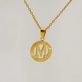 Detailed macro view of 18K gold letter M hollow circular pendant on thin chain - Letter M