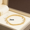 Detailed view of 3mm 18K gold-plated beads on an elastic bracelet in a velvet box - 3mm