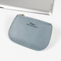 Blue-grey litchi pattern leather mini coin purse with golden zipper on a white desk - Sky Blue