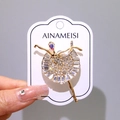 Elegant gold ballerina brooch featuring sparkling rhinestones and a central iridescent stone - Ballet Dancer Gold