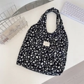 Detail of canvas tote bag showing black and white heart pattern and woven label - Corduroy Leopard Heart Black
