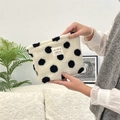 Close-up of soft plush makeup bag with black polka dots and colorful woven label - Black White Polka Dot
