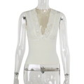 Detailed view of the deep V-neckline with lace trim and bow knot on a white ribbed vest - S / Off White
