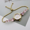 Detail of gold quartz watch with pink heart gemstones and mother of pearl dial - Gold Pink