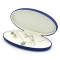 Navy blue oval jewelry box displaying a white pearl earring, necklace, and ring set - Blue Set Box