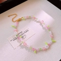 Detailed macro view of handmade floral ceramic bead necklace with gold lobster clasp - Pink White Green/Fresh Flower