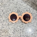 Macro shot of pink flower-shaped toddler sunglasses with UV400 protection lens - Glossy Beige Orange