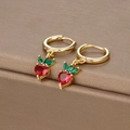 Macro view of gold-plated strawberry earrings with red heart-shaped crystals - Gold Strawberry