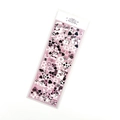 Detailed view of pink laser stickers featuring cow patterns and hearts in transparent bag - Pink Cow