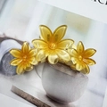 Translucent yellow frangipani hair claw clip made of resin with polished floral design - Yellow