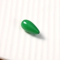 Macro shot of a smooth green teardrop-shaped resin charm for DIY jewelry making and crafts - 1 Piece / Green