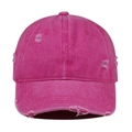 Close-up of distressed rose pink baseball cap with vintage washed fabric and ripped details - Rose Red