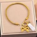 Golden bow and baroque pearl charm bracelet in a minimalist jewelry gift box - Bow