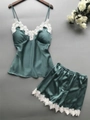Detailed view of dark green satin pajama set with elegant white lace trimmings and V-neck - S / Green