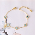 Golden clover bracelet with white enamel and blue evil eye charms, adjustable cable chain - Four Petal Flower