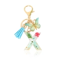 Letter X keychain with sky blue tassel, green butterfly and pink dried flowers in resin - Letter X