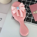 Pink bow hair brush with massage air cushion and blue ribbon detail on laptop - Sakura Pink Bow - Handle Comb