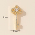Detail showing the 3.1cm x 1.5cm golden key pendant with crystals on beige background - Gold Rhinestone Key