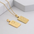 Macro view of a gold-plated Aquarius rectangular pendant necklace made of stainless steel - Aquarius